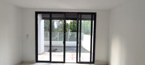 Block B-view from corner unit's living room to terrace and hammock garden. 