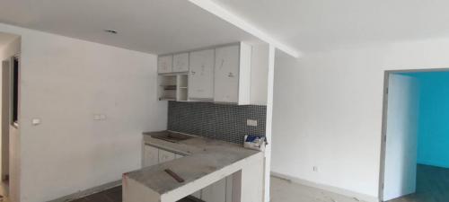 View of kitchen cabinets installation in progress. 