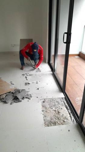 Block B - Workers repairing chipped tiles.