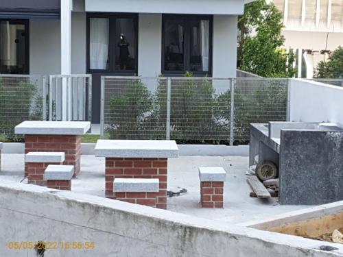 Podum - view of BBQ area and sitting furniture.